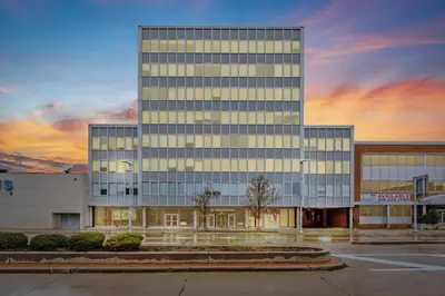 a large glass building with a sunset in the background at King Bed Comfort, Bidet, Fast Wi-Fi, Parking in Cleveland