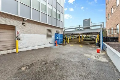 a parking lot next to a building with a garage at King Bed Comfort, Bidet, Fast Wi-Fi, Parking in Cleveland