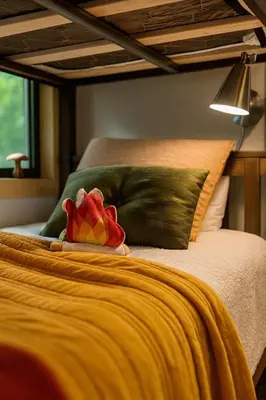 a red flower sitting on top of a bed at Lux Tiny House with Waterfront, Kayaks, Hot Tub, Arcade in Rockbridge