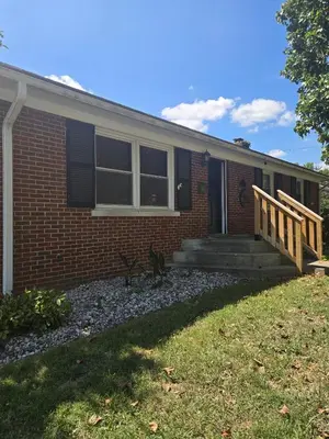 a brick house with a porch and a deck at La Casa delle Pesche in Georgetown