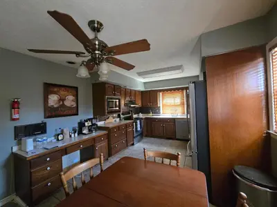 a kitchen with a dining table and a ceiling fan at La Casa delle Pesche in Georgetown