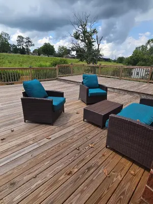 three chairs on a deck with blue cushions at La Casa delle Pesche in Georgetown