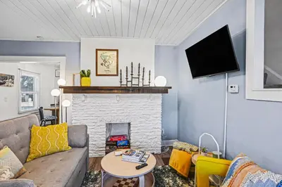a living room with a couch and a fireplace at Cozy Campbell Bungalow in Columbus