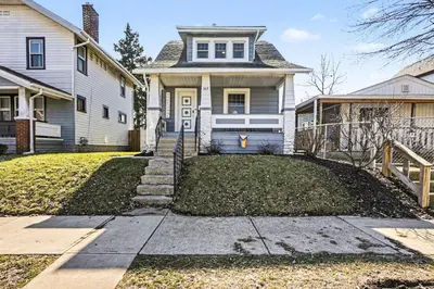 a home with a white house with a driveway at Cozy Campbell Bungalow in Columbus