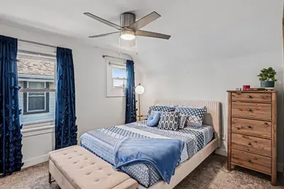 a bedroom with a bed and a ceiling fan at Cozy Campbell Bungalow in Columbus