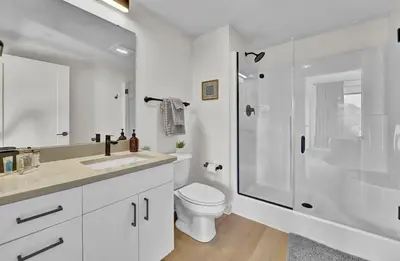 a white bathroom with a toilet and a shower at Stay in Cleveland mins to Cleveland Clinic, Hospitals, Museum, Universities & Downtown in Cleveland