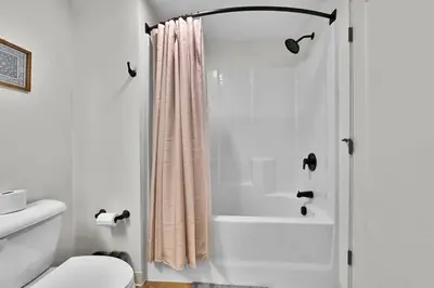 a bathroom with a shower curtain and a toilet at Stay in Cleveland mins to Cleveland Clinic, Hospitals, Museum, Universities & Downtown in Cleveland