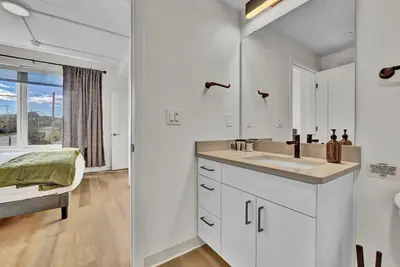 a white bathroom with a sink and a window at Stay in Cleveland mins to Cleveland Clinic, Hospitals, Museum, Universities & Downtown in Cleveland