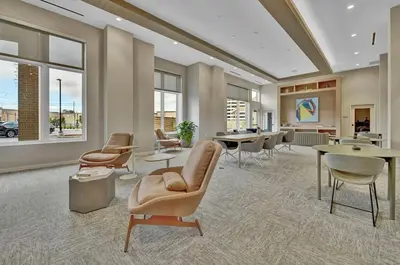 a lobby with chairs and tables and windows at Stay in Cleveland mins to Cleveland Clinic, Hospitals, Museum, Universities & Downtown in Cleveland