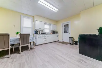 a large kitchen with a table and a counter at Just Like Home in Cleveland