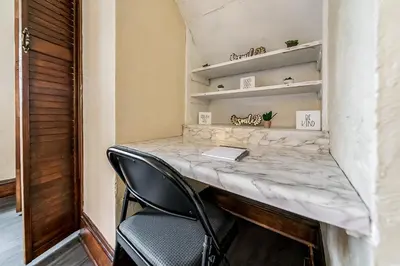 a desk in a room with a black chair at Just Like Home in Cleveland