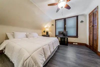 a bedroom with a bed and a ceiling fan at Just Like Home in Cleveland