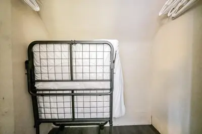 a metal bunk bed in a room with a wall at Just Like Home in Cleveland