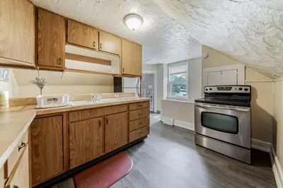 a kitchen with wooden cabinets and a stove at Just Like Home in Cleveland