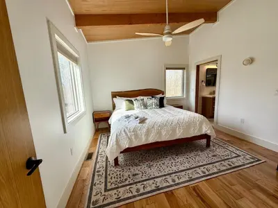 a bedroom with a bed with a rug and a ceiling at The Briar House in McArthur