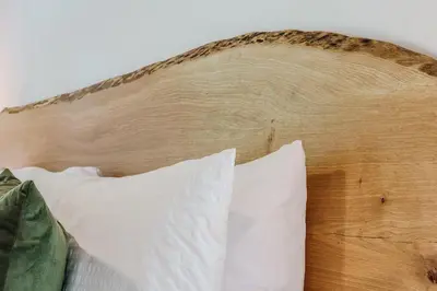 a wooden headboard with white pillows on a bed at The Briar House in McArthur