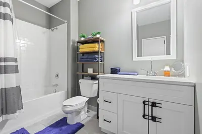 a bathroom with a sink and a toilet and a mirror at 1BR • City Views • Queen + SofaBed • WiFi & 2 TVs in Cleveland