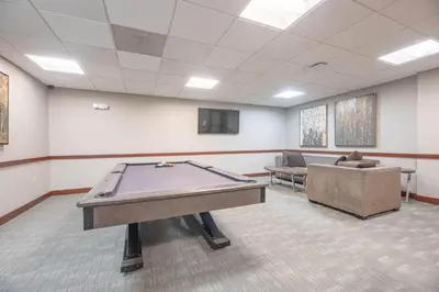 a large room with a pool table and a couch at 1BR • City Views • Queen + SofaBed • WiFi & 2 TVs in Cleveland