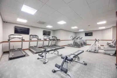 a gym with several cardio machines in a room at 1BR • City Views • Queen + SofaBed • WiFi & 2 TVs in Cleveland