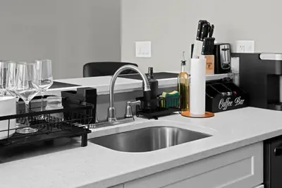 a kitchen counter with a sink and wine glasses at 1BR • City Views • Queen + SofaBed • WiFi & 2 TVs in Cleveland