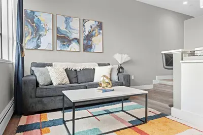 a living room with a couch and a table at 1BR • City Views • Queen + SofaBed • WiFi & 2 TVs in Cleveland