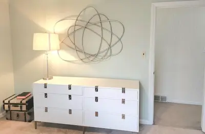 a bedroom with a white dresser and a lamp at Your Home Away from Home Sleeps 12 Fully Equipped in Youngstown