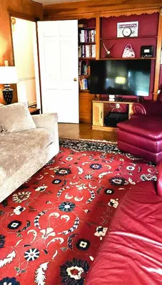 a living room with a red rug and a couch at Your Home Away from Home Sleeps 12 Fully Equipped in Youngstown