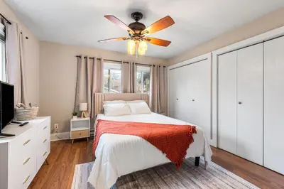 a bedroom with a bed and a ceiling fan at Spacious Home Near Hospitals with Office & Game Room in Cleveland Heights