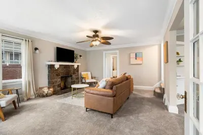 a living room with a couch and a fireplace at Spacious Home Near Hospitals with Office & Game Room in Cleveland Heights