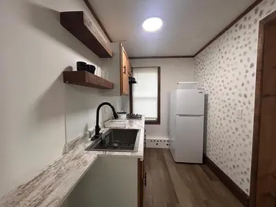 a small kitchen with a sink and a refrigerator at A gem in the heart of Cleveland Unit 3 in Cleveland