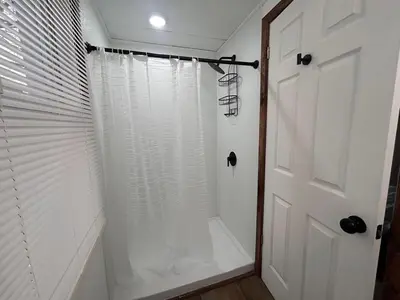 a shower with a white shower curtain in a bathroom at A gem in the heart of Cleveland Unit 3 in Cleveland