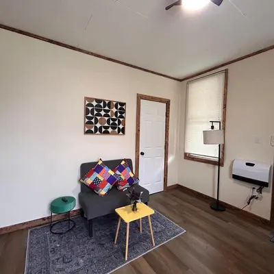 a living room with a couch and a table at Urban OASIS Inspired by the 80s Unit 1 in Cleveland