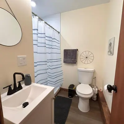a bathroom with a sink and a toilet and a shower at Urban OASIS Inspired by the 80s Unit 1 in Cleveland