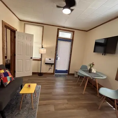 a living room with a couch and a table at Urban OASIS Inspired by the 80s Unit 1 in Cleveland