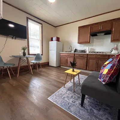a kitchen with a couch and a table and a refrigerator at Urban OASIS Inspired by the 80s Unit 1 in Cleveland