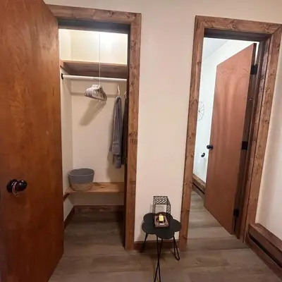a hallway with a door and a table in a room at Urban OASIS Inspired by the 80s Unit 1 in Cleveland