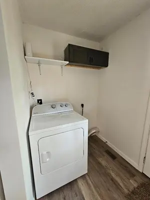 a washer and dryer in a small room at Cozy 3BR Cottage Near Headlands in Mentor