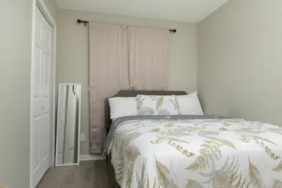a bedroom with a bed with a comforter on it at Comfortable and Calm Stay in Columbus in Columbus