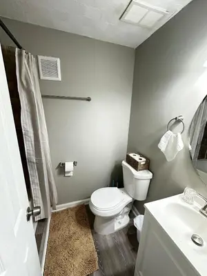 a bathroom with a toilet and a sink at Comfortable and Calm Stay in Columbus in Columbus