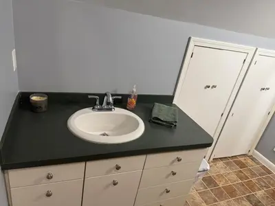 a bathroom with a sink and a black counter at Old Orchard Kirtland, Ohio