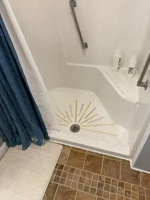 a bathroom with a tub with a sun painted on it at Old Orchard Kirtland, Ohio