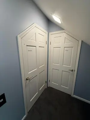 two white doors in a room with blue walls at Old Orchard Kirtland, Ohio