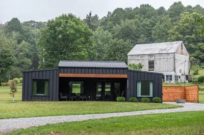 a black house with a gray roof at Ravenwood in Killbuck