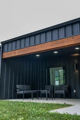 a group of chairs sitting outside of a building at Ravenwood in Killbuck