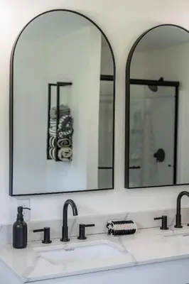 a bathroom with two mirrors above a sink at Ravenwood in Killbuck