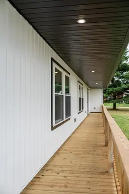 a porch with a wooden walkway on a house at The Gathering Haus in Dalton
