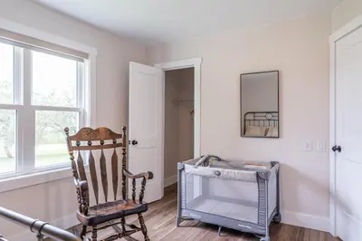 a room with a rocking chair and a window at The Gathering Haus in Dalton