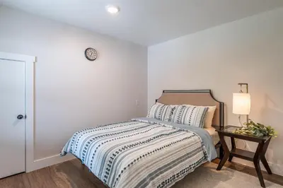 a bedroom with a bed and a clock on the wall at The Gathering Haus in Dalton