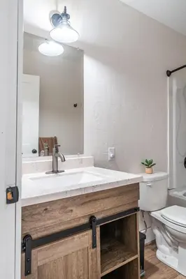 a bathroom with a sink and a toilet at The Gathering Haus in Dalton