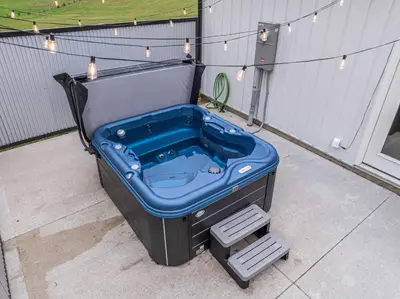 a jacuzzi tub sitting on a patio with lights at Swancrest in Killbuck